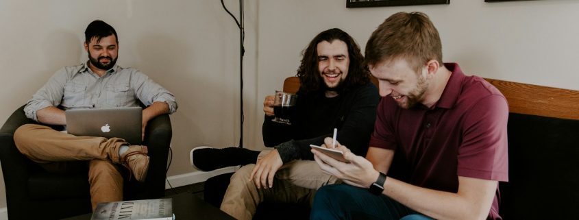 men sitting on sofa